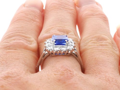 fig 9. A vintage platinum dress ring featuring a cushion-cut blue Ceylon sapphire surrounded by a cluster of round brilliant-cut diamonds.