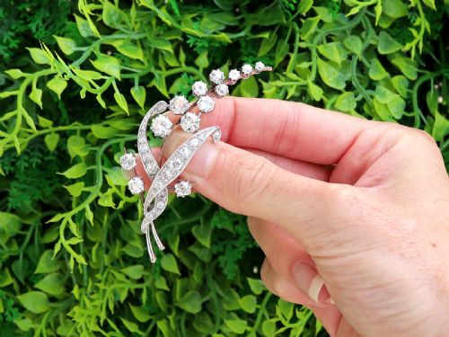 fig 1. An antique 18ct white gold floral spray brooch set with round diamonds in a stylized leaf sprig design.