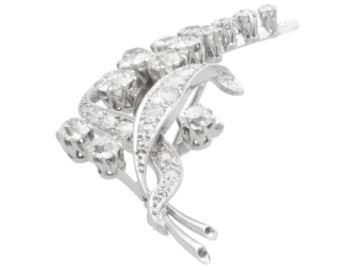 fig 4. An antique 18ct white gold floral spray brooch set with round diamonds in a stylized leaf sprig design.