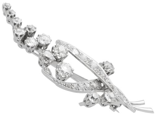 fig 5. An antique 18ct white gold floral spray brooch set with round diamonds in a stylized leaf sprig design.