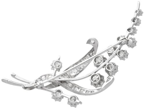 fig 6. An antique 18ct white gold floral spray brooch set with round diamonds in a stylized leaf sprig design.