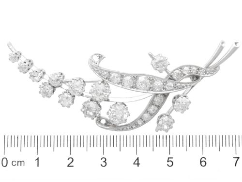 fig 8. An antique 18ct white gold floral spray brooch set with round diamonds in a stylized leaf sprig design.