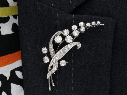 fig 9. An antique 18ct white gold floral spray brooch set with round diamonds in a stylized leaf sprig design.