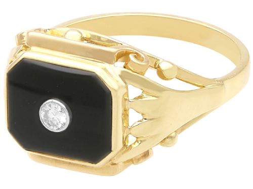 fig 3. A 14ct yellow gold signet ring set with an octagonal black onyx plaque featuring a central round diamond bezel setting.