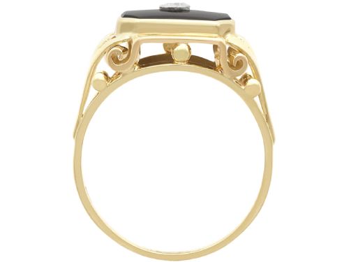 fig 5. A 14ct yellow gold signet ring set with an octagonal black onyx plaque featuring a central round diamond bezel setting.