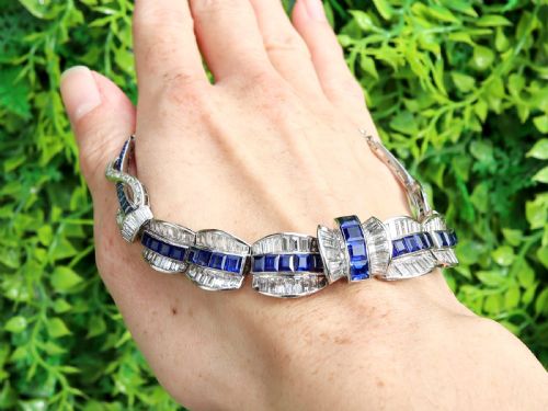 fig 1. An Art Deco platinum collar necklace set with central square-cut blue sapphires bordered by baguette and round diamonds.