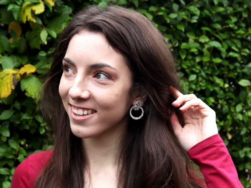 fig 8. Pair of platinum clip-on earrings featuring circular diamond-set lower hoops suspended from geometric diamond scroll tops.