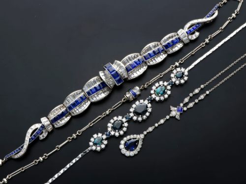 fig 8. An Art Deco platinum collar necklace set with central square-cut blue sapphires bordered by baguette and round diamonds.
