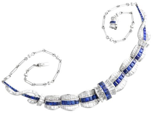 fig 9. An Art Deco platinum collar necklace set with central square-cut blue sapphires bordered by baguette and round diamonds.