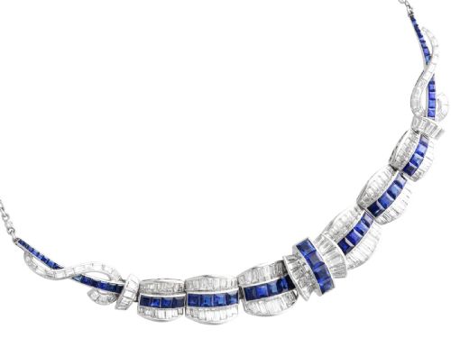 fig 10. An Art Deco platinum collar necklace set with central square-cut blue sapphires bordered by baguette and round diamonds.