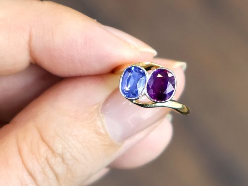 fig 2. An Edwardian 18ct yellow gold twist ring set with a cushion cut blue sapphire and pink sapphire in platinum settings.