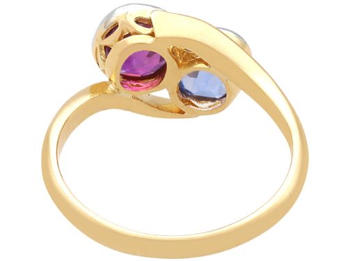 fig 7. An Edwardian 18ct yellow gold twist ring set with a cushion cut blue sapphire and pink sapphire in platinum settings.