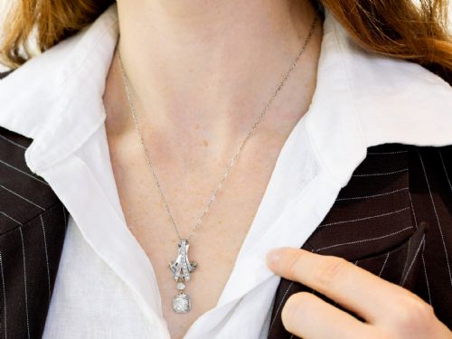 fig 3. An Art Deco platinum pendant set with brilliant-cut diamonds featuring a geometric ribbon motif suspended above a central diamond drop.