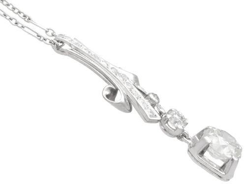 fig 7. An Art Deco platinum pendant set with brilliant-cut diamonds featuring a geometric ribbon motif suspended above a central diamond drop.
