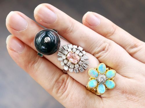fig 4. An antique circular bloodstone cabochon ring featuring a central inset diamond, mounted in 14ct white gold with green gem-set shoulders.