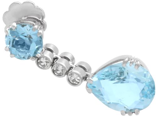 fig 4. A pair of 14ct white gold drop earrings featuring round and pear-cut light blue aquamarines joined by a vertical line of small round diamonds.