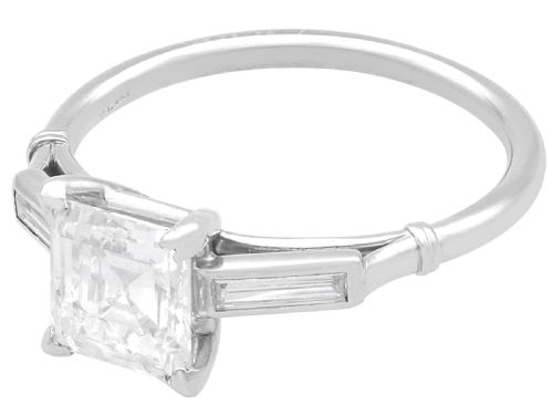 fig 6. An Art Deco platinum ring featuring a central square step-cut diamond set between two horizontal baguette side stones.
