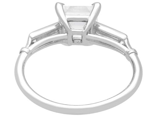 fig 7. An Art Deco platinum ring featuring a central square step-cut diamond set between two horizontal baguette side stones.