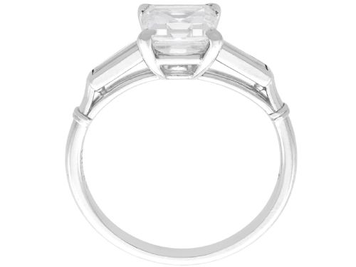 fig 8. An Art Deco platinum ring featuring a central square step-cut diamond set between two horizontal baguette side stones.