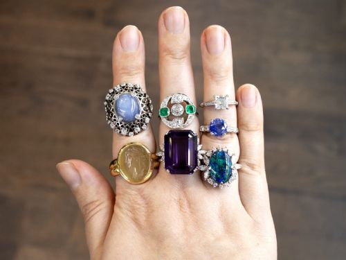 fig 6. A round blue sapphire set in a platinum band flanked by round diamonds on each side.