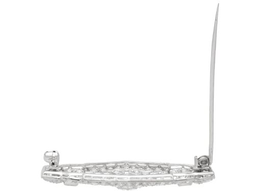 fig 9. An Art Deco platinum plaque brooch featuring an intricate geometric openwork setting encrusted with round and baguette cut diamonds.