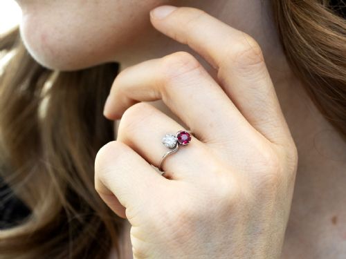 fig 2. An Art Deco platinum twist ring featuring a circular red Burmese ruby and a brilliant white diamond set side by side on a curved band.