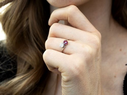 fig 3. An Art Deco platinum twist ring featuring a circular red Burmese ruby and a brilliant white diamond set side by side on a curved band.
