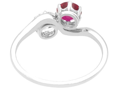 fig 5. An Art Deco platinum twist ring featuring a circular red Burmese ruby and a brilliant white diamond set side by side on a curved band.