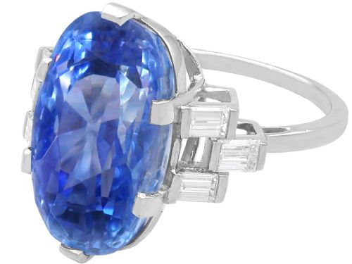 fig 7. A large oval blue Ceylon sapphire set in platinum with stepped baguette diamond shoulders.