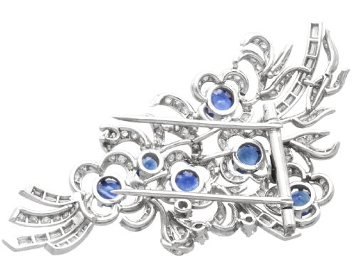 fig 8. An Art Deco platinum brooch styled as a floral spray, set with round blue sapphires and accented with pave and baguette-cut diamonds.