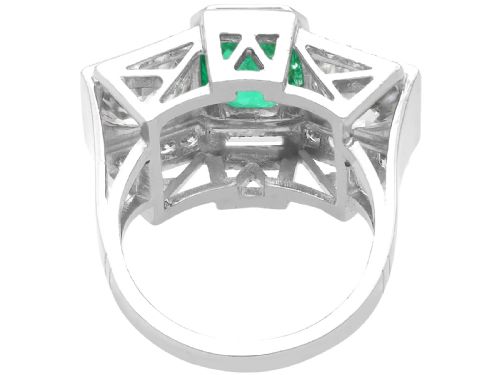 fig 9. An Art Deco platinum cocktail ring set with a central rectangular emerald flanked by round diamonds and baguette diamonds.
