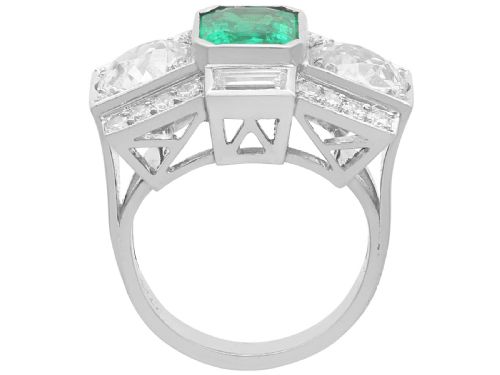 fig 10. An Art Deco platinum cocktail ring set with a central rectangular emerald flanked by round diamonds and baguette diamonds.