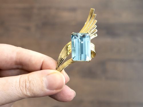 fig 3. A large emerald-cut blue aquamarine set within a sweeping, ribbed 18ct yellow gold mount.