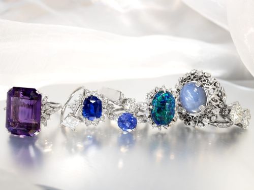 fig 6. An oval cabochon blue star sapphire set in platinum surrounded by an intricate openwork diamond halo.
