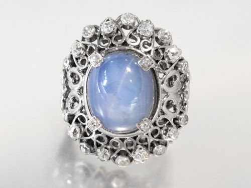 fig 7. An oval cabochon blue star sapphire set in platinum surrounded by an intricate openwork diamond halo.