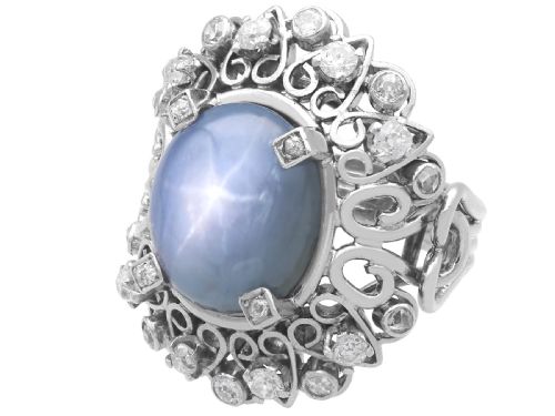 fig 8. An oval cabochon blue star sapphire set in platinum surrounded by an intricate openwork diamond halo.