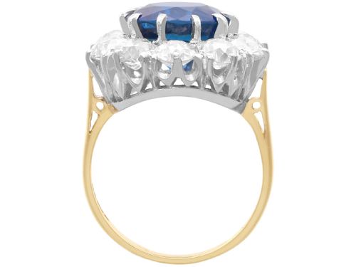 fig 9. A round deep blue sapphire framed by a halo of ten round brilliant diamonds on an 18ct yellow gold band.