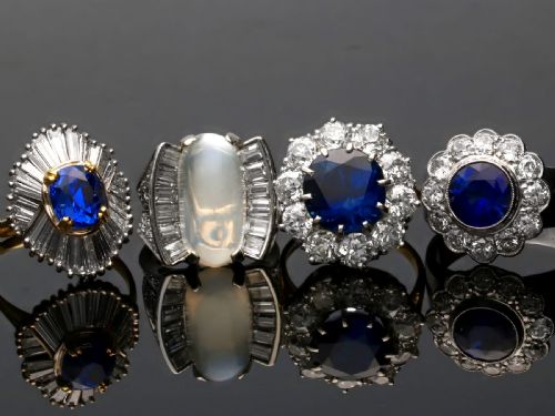 fig 5. An Art Deco platinum dress ring featuring a central oval cabochon moonstone flanked by stepped baguette-cut diamonds.