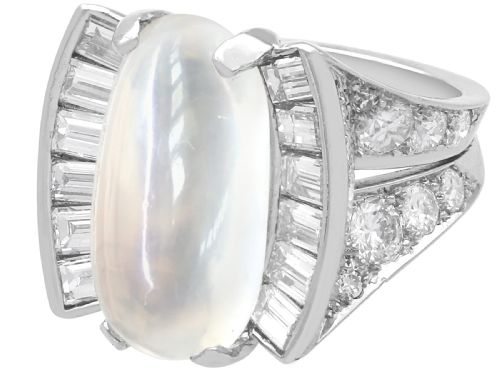 fig 9. An Art Deco platinum dress ring featuring a central oval cabochon moonstone flanked by stepped baguette-cut diamonds.