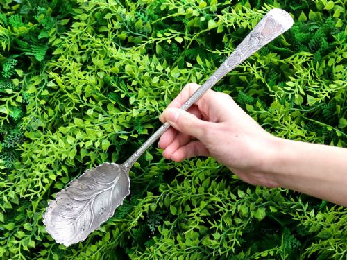 fig 2. Pair of antique George III sterling silver salad servers with leaf-shaped bowls and engraved stems.