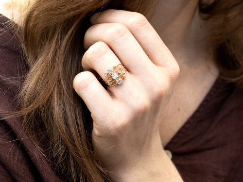 fig 4. An 18ct yellow gold Victorian dress ring featuring three openwork bands set with cushion-cut and round diamonds.