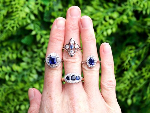 fig 2. An 18ct yellow gold Victorian trilogy ring featuring three blue sapphires framed by a border of small diamonds.