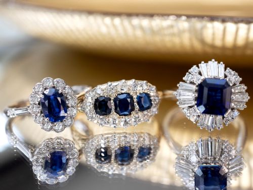fig 3. An 18ct yellow gold Victorian trilogy ring featuring three blue sapphires framed by a border of small diamonds.