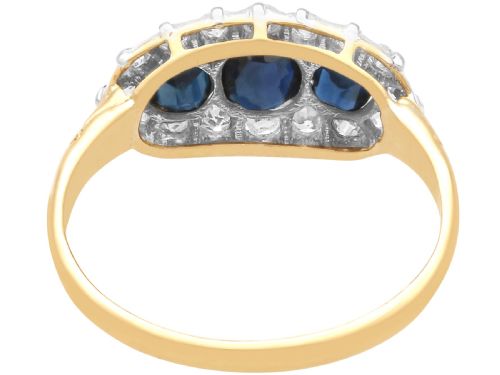 fig 7. An 18ct yellow gold Victorian trilogy ring featuring three blue sapphires framed by a border of small diamonds.