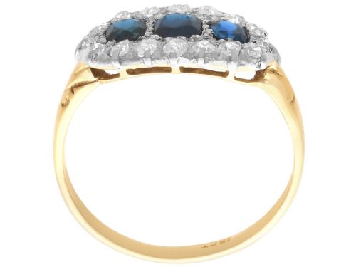 fig 8. An 18ct yellow gold Victorian trilogy ring featuring three blue sapphires framed by a border of small diamonds.