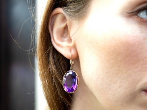 fig 4. A pair of antique 9ct gold drop earrings featuring large oval faceted purple amethysts on leverback ear wires.