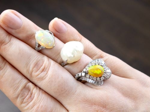 fig 4. An antique platinum dress ring featuring a large, smooth natural blister pearl flanked by diamond-set shoulders.