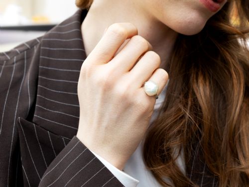 fig 5. An antique platinum dress ring featuring a large, smooth natural blister pearl flanked by diamond-set shoulders.