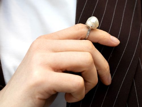 fig 6. An antique platinum dress ring featuring a large, smooth natural blister pearl flanked by diamond-set shoulders.