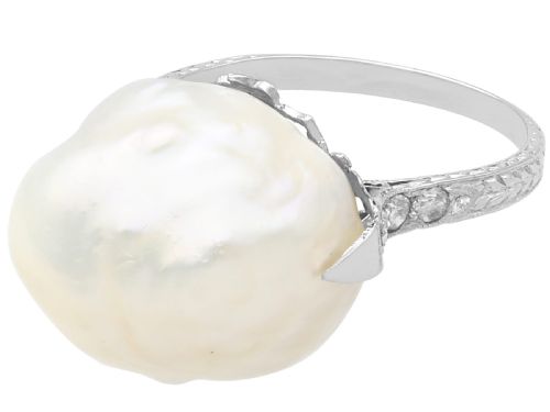 fig 8. An antique platinum dress ring featuring a large, smooth natural blister pearl flanked by diamond-set shoulders.